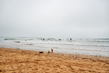 Fototapeta na wymiar Surfers practicing at the beach