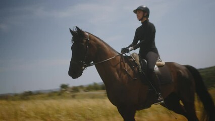 Woman riding horse enjoying horseback riding hobby in nature