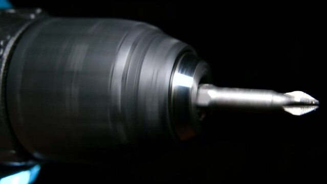 Rotation of an electric drill with screwdriver in slow motion