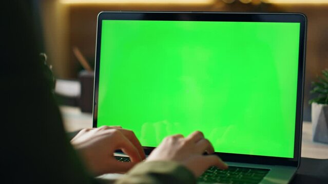 Hands typing greenscreen laptop at office closeup. Freelancer working chroma key