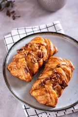 Swedish fika time with close up of  cinnamon buns nuts and maple syrup  on the table vertical view