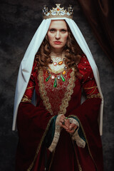 medieval queen in red dress with veil and crown