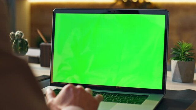 Worker scrolling touchpad green screen laptop at office workplace close up.