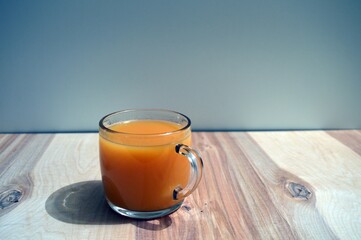 Full glass of pressed delicious juice mango banana carrot apple on the table