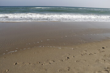 sea. beach. footprints in the sand.