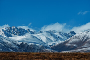 Fototapeta na wymiar Snow-covered mountain peaks in Kyrgyzstan