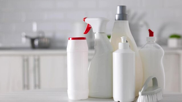A set of different cleaning and disinfection products against the background of the home interior 