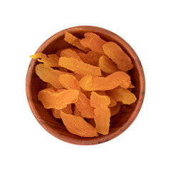 slices of dried apricots in wooden bowl isolated on white background, top view, flat lay, concept of healthy breakfast