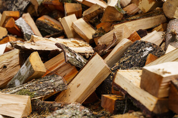 Dry chopped firewood in a pile. Abstraction and background