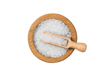 Sea salt in wooden bowl on black table.
