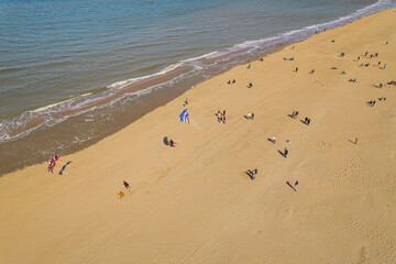 people relaxing on the beach on a spring sunny day, aerial shot. beach and the beautiful sea. High quality photo