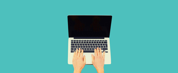 Close up female hands woman working with laptop and blank black screen on blue background