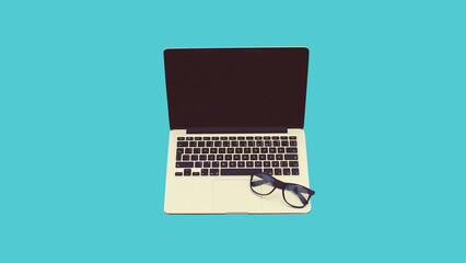 Close up laptop with blank black screen and eyeglasses on blue background