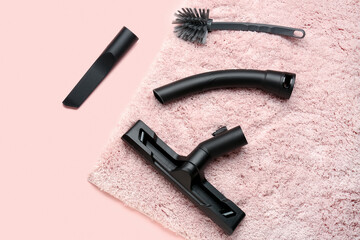 Vacuum cleaner attachments with carpet on pink background