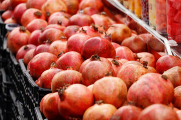 fresh pomegranate fruits displayed in a juice shop to make healthy drinks