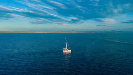 Boat moving on the sea. Sailing boat on the sea at sunset