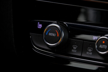 Fototapeta premium Close up dark menu button inside car panel. Selective focus.