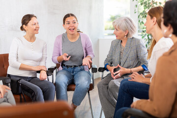 Fototapeta premium Young female teacher giving lecture to group of students in classroom