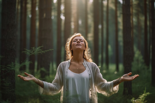 A woman is meditating in a forest