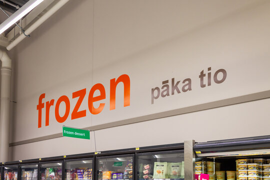 Queenstown, New Zealand - April 20, 2023: Signage above the frozen section of a New Zealand supermarket also displaying the Maori translation for frozen, paka tio.