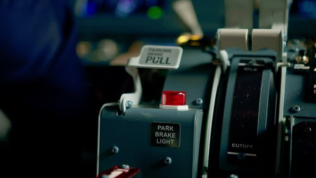 close-up of the control panel in the airplane cockpit the pilot presses the parking brake button flight simulator