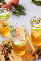 Refreshing fall cocktail, apple cider drink with apple slices and thyme