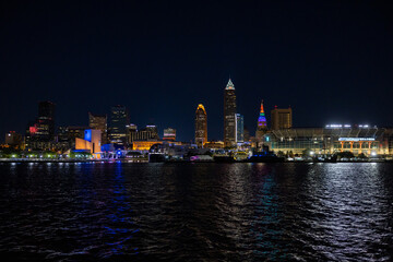 Fototapeta na wymiar Cleveland Downtown from Lake Erie during night with illuminated skyline.
