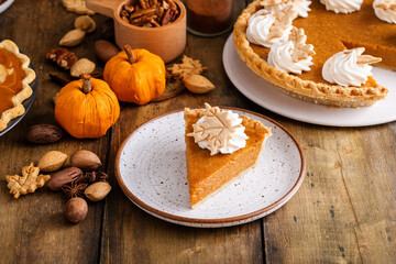 Fototapeta na wymiar Traditional pumpkin pie for Thanksgiving with whipped cream