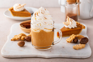 Obraz na płótnie Canvas Pumpkin pie latte with whipped cream and cinnamon