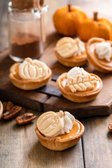 Mini pumpkin pies with pumpkin and fall leaves decoration
