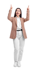Beautiful businesswoman in suit pointing at something on white background
