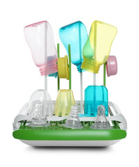 Dryer with baby bottles and nipples after sterilization on light grey table against white background