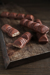 Tasty chocolate bars on wooden table, closeup