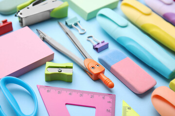 Many different school stationery on light blue background, closeup. Back to school