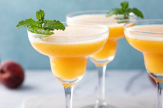 Frozen Peach Margaritas In Three Glasses With Mint