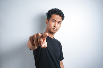 Young handsome man wearing t-shirt white background pointing to you and the camera with fingers, smiling positive and cheerful