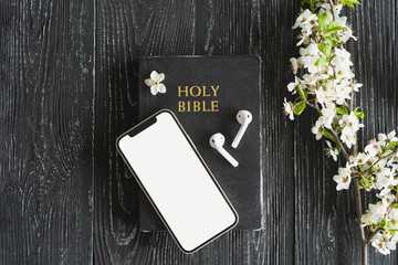 Study Bible worship online concept. Church online Sunday new normal concept. Bible, cell phone and...
