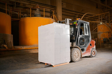 Forklift with stack of finished blocks in plant workshop