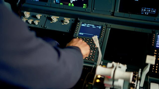 The pilot presses the power buttons on the control panel to control the aircraft during the flight simulator