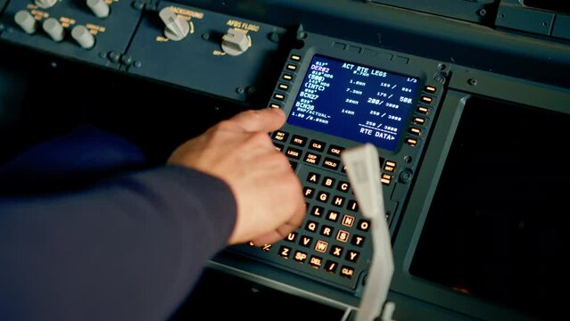The pilot presses the power buttons on the control panel to control the aircraft during the flight simulator