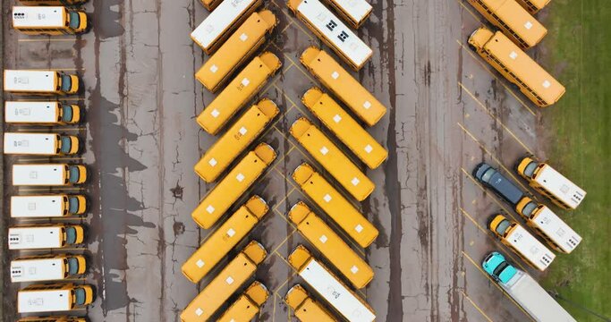 Aerial video of rows of parked school buses