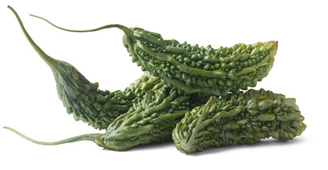 pile of bitter gourd or bitter melon, momordica charantia, tropical vegetable with oblong shape and bitter taste, commonly used in asian, african and caribbean cuisines, isolated
