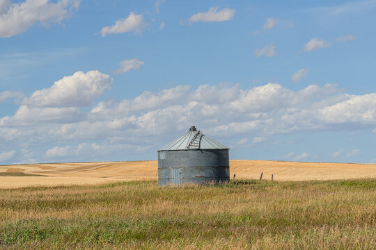 Grain silo in the prairie with cloudy blue sky, Alberta, Canada
