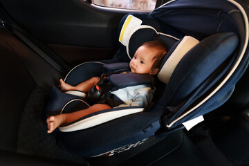 newborn baby sitting in infant car seat, safety chair travelling
