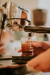 pouring espresso into a glass