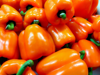 large quantity of loose red peppers with green caps