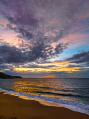 Fototapeta premium Sunrise seascape with clouds and gentle surf