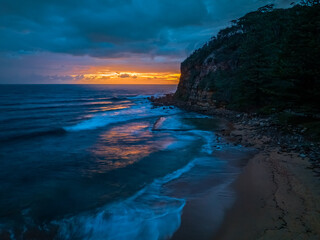 Fototapeta na wymiar Rain clouds and sunrise at the seaside