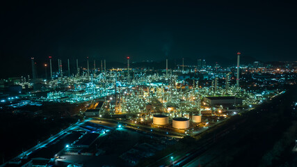 Fototapeta na wymiar Oil refinery plant from industry zone, Aerial view oil and gas petrochemical industrial, Refinery factory oil storage tank and pipeline steel at night over lighting,