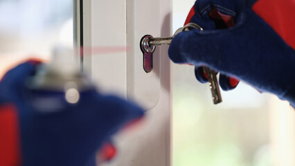 Master in gloves checking pvc windows locks with keys - obrazy, fototapety, plakaty